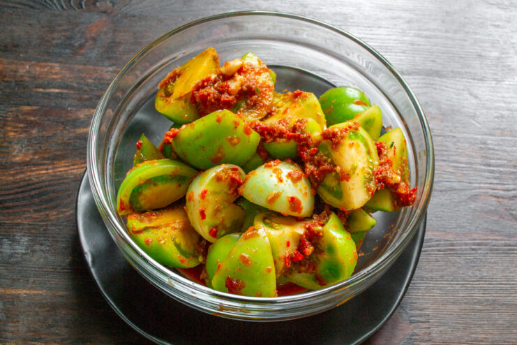 Serving Green Tomato Kimchi A serving of finished green tomato kimchi in a small bowl, ready to be eaten as an appetizer.