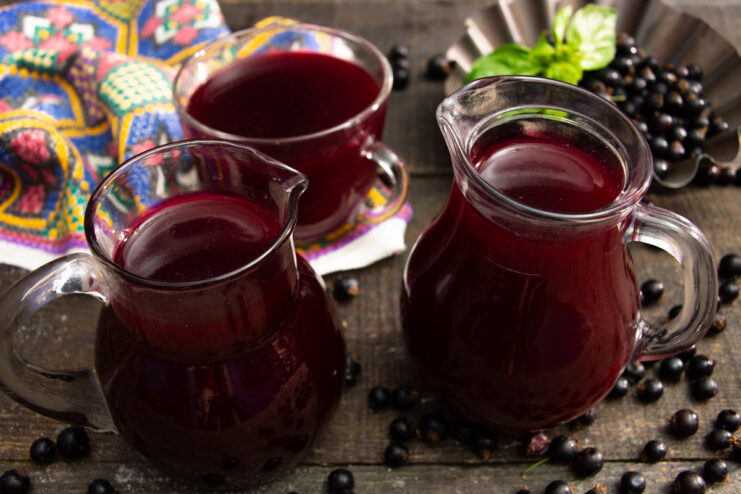 A glass filled with vibrant purple blackcurrant kissel, ready to be served.