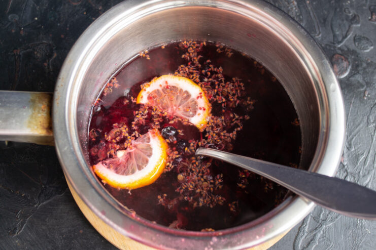 Using the leftover berry pomace to create a flavorful base for the kisel Blackcurrant pomace (pulp and skins) in a saucepan with water, ready to be boiled.