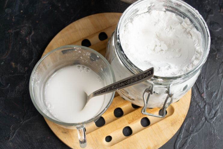 Making a potato starch slurry to thicken the kisel without lumps A small bowl with potato starch being mixed with water to create a slurry.