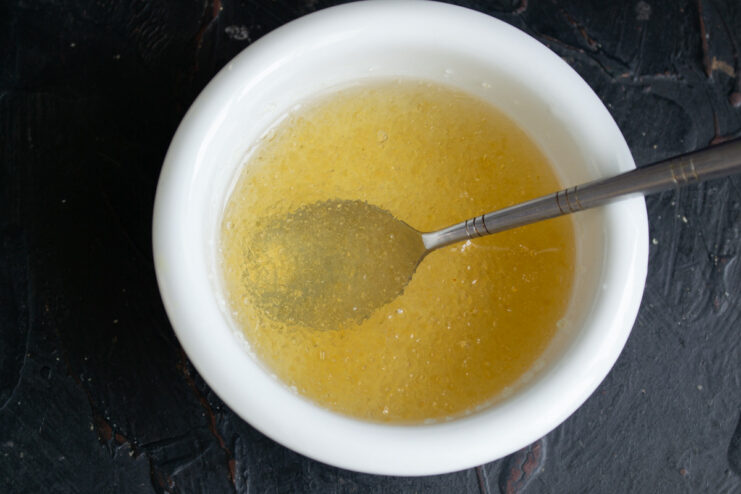 Step 5: Blooming gelatin in cold water for the filling. Gelatin powder soaking and blooming in a small glass bowl of water.