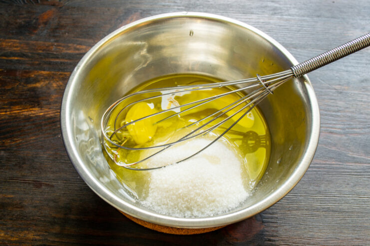 You can prepare the batter by hand or use a blender for a smoother consistency Mixing muffin batter in a food processor with eggs and sugar.