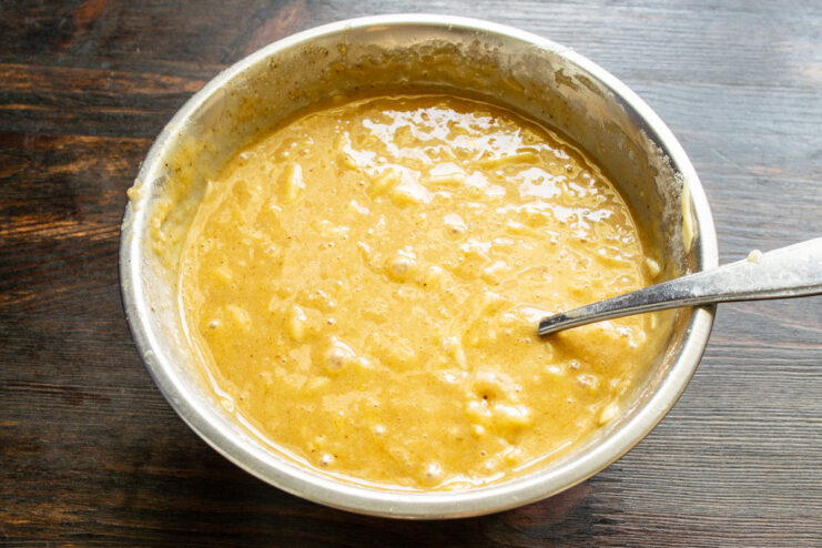 The perfect combination of banana, coffee, and vanilla creates an irresistible aroma Thick, aromatic coffee and banana muffin batter being mixed with a spatula.