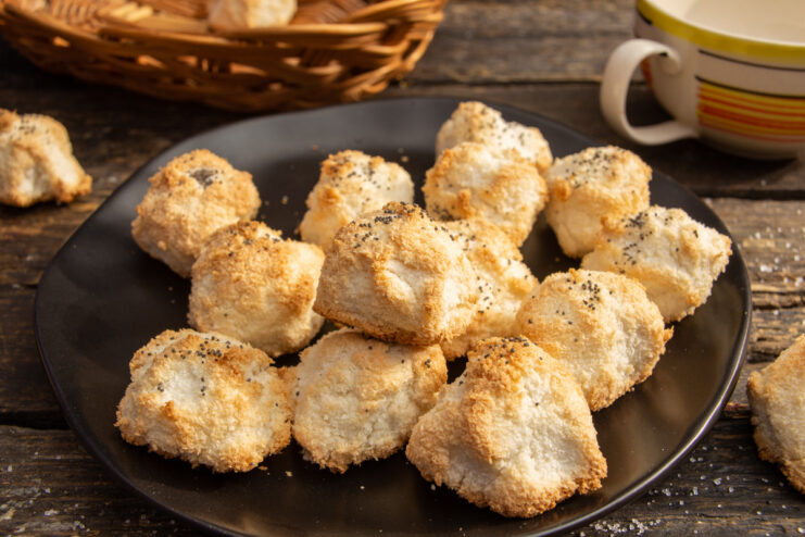 A plate of gluten-free coconut and poppy seed cookies, ready to eat.