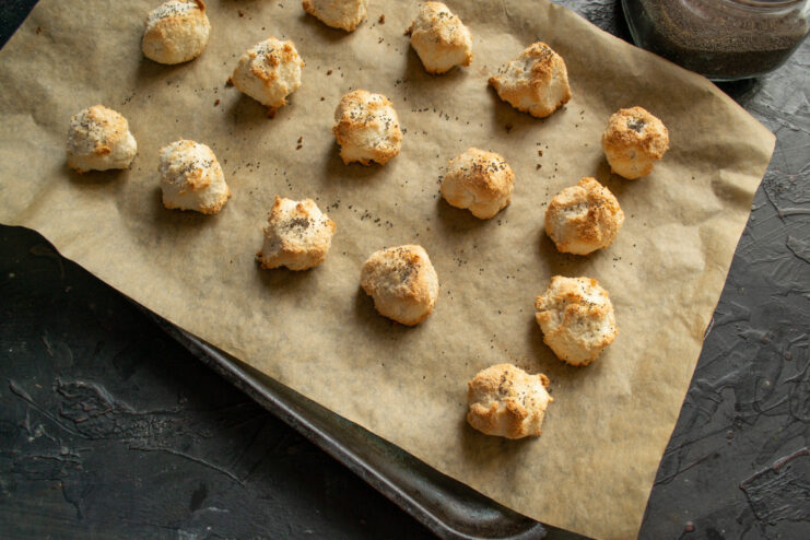 Baking the Coconut Cookies for About 20 Minutes A baking sheet with coconut and poppy seed cookies baking in the oven.