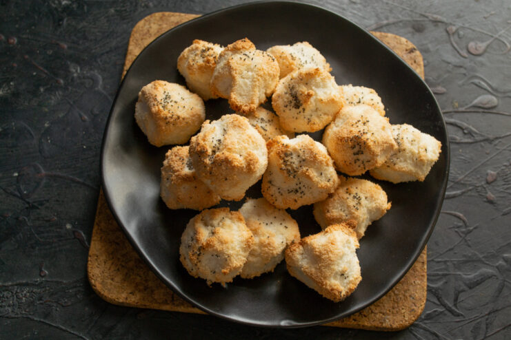 Storing Freshly Baked Coconut Cookies for Lasting Crispiness A batch of golden-brown coconut and poppy seed cookies cooling on a wire rack.