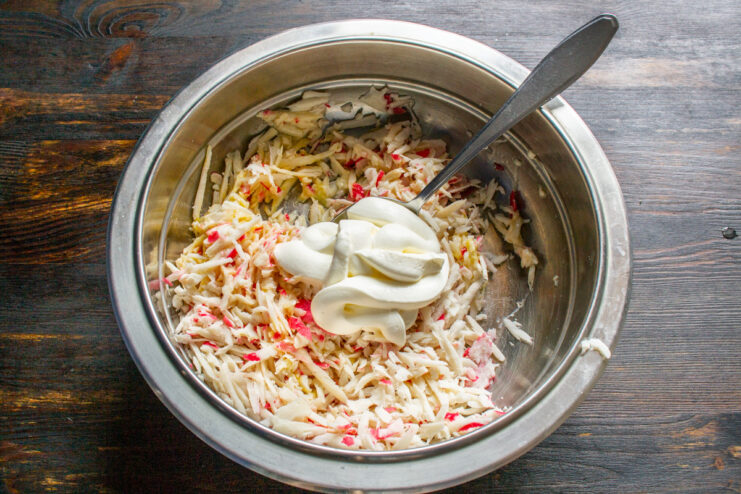 Adding Creaminess with Smetana - A key ingredient for moist and tender cutlets. Adding a spoonful of thick smetana (sour cream) to the crab stick and egg mixture.