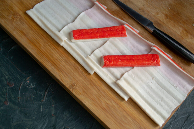 A package of chilled crab sticks being prepared for the recipe.