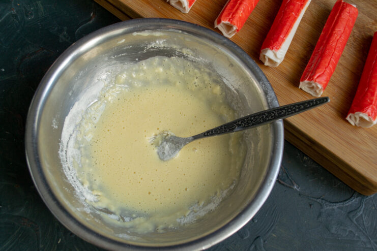 Sparkling water being poured into the egg and flour mixture for the batter.