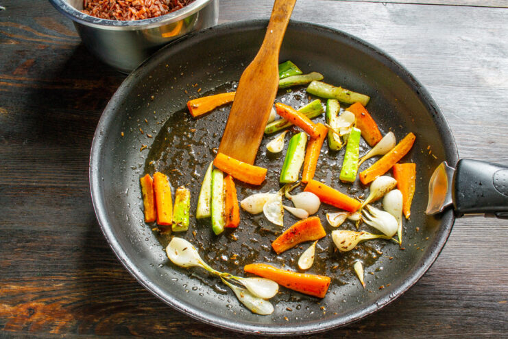 How to cook vegetables al dente for a crunchy texture. Vegetables being sautéed in a frying pan, still looking crisp and vibrant.