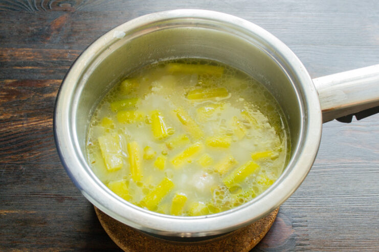 Tip: Cook vegetables until very soft for an extra creamy soup. Cooked asparagus and potatoes simmering in broth, ready for blending.