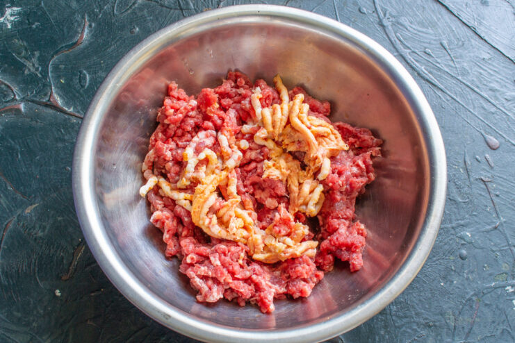 Step 2: Adding Cured Fat to the Sausage Mixture Cured salo (pork fat) being put through a meat grinder.