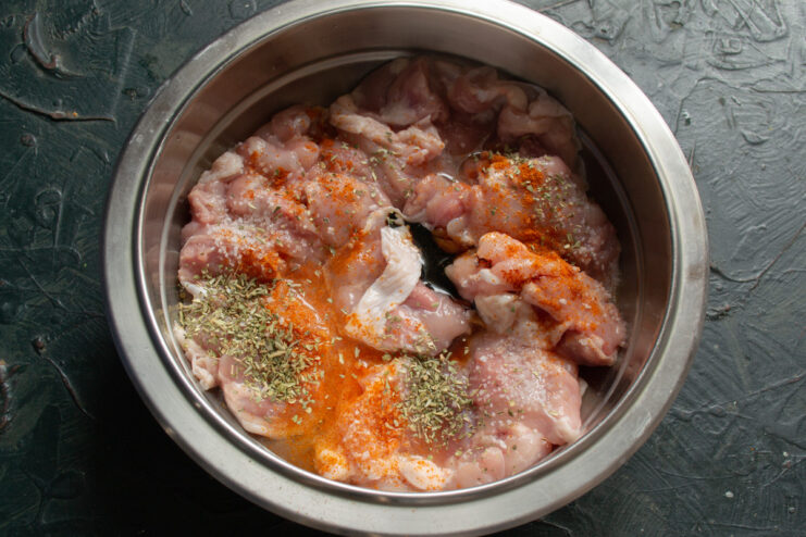 Seasoning the Chicken with Herbes de Provence and Paprika Adding a mix of dried herbs and spices to the chicken marinade.