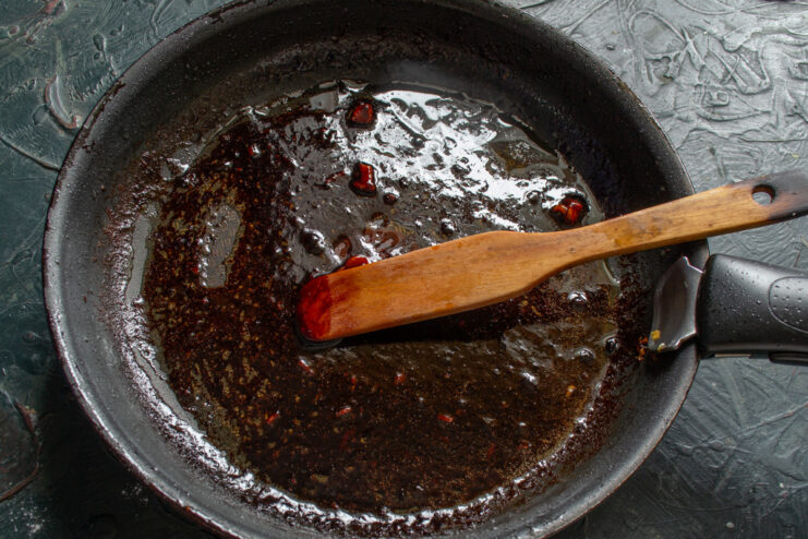 Reducing the Pomegranate Sauce to a Perfect Glaze Pomegranate sauce simmering and reducing in a skillet.