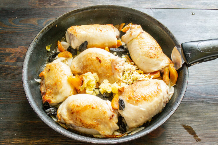 Building Flavor with Ginger and Garlic Grated ginger and minced garlic being added to the skillet.