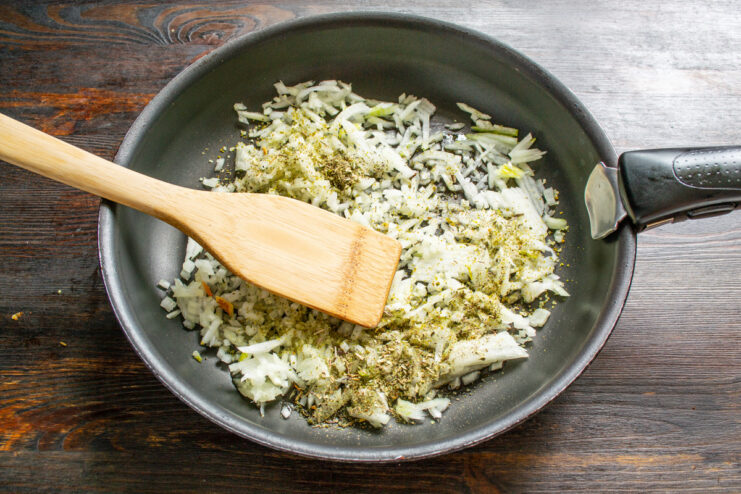 Step-by-Step Guide to the Savory Meat Filling Chopped onions being sautéed in a pan for the lasagna filling.