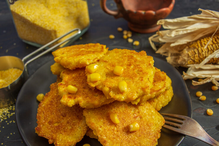 A plate of golden-brown canned corn fritters, ready to serve.