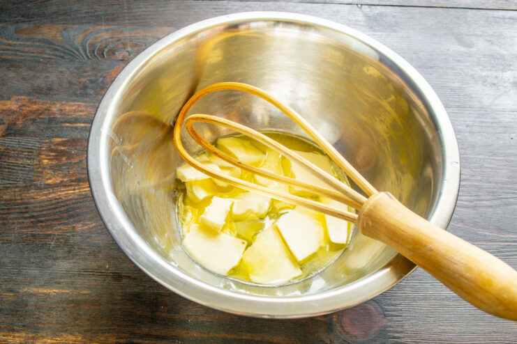 Preparing the butter for the pound cake batter. A bowl of softened butter being prepared for the lemon pound cake batter.