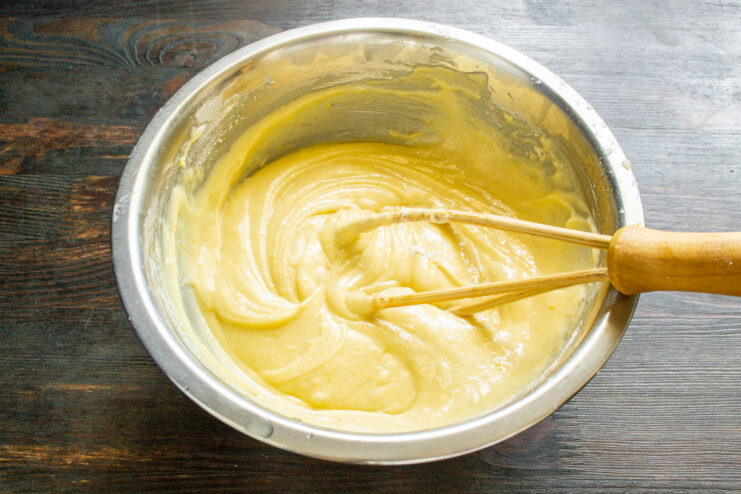 The perfect consistency for a rich and buttery pound cake batter. A bowl of perfectly mixed, thick, and glossy lemon pound cake batter.