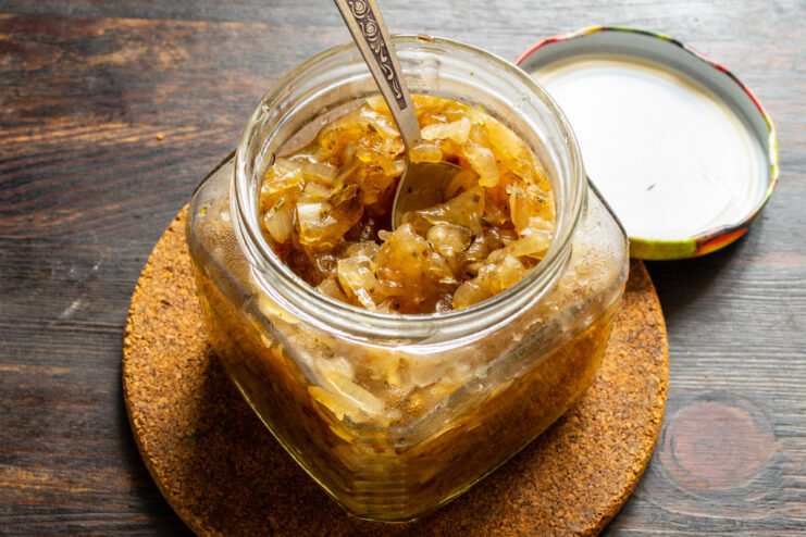 Storing the Finished Onion Jam Transferring the finished, thick onion jam from the skillet into a clean glass jar.