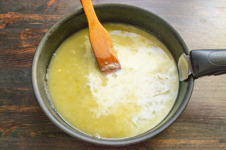 Adding Cream for a Rich and Velvety Sauce Heavy cream being poured into the sauce in a skillet to make it rich.