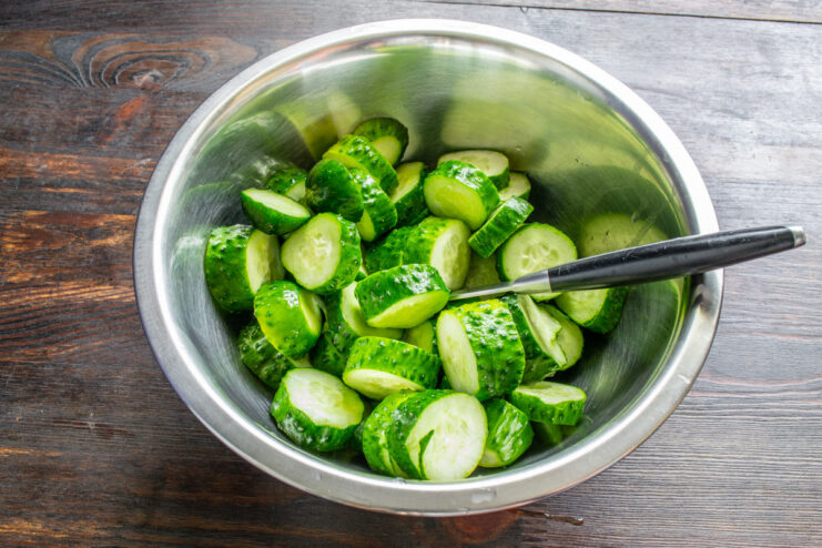 Soaking Cucumbers for Maximum Crunchiness Fresh cucumbers soaking in a large bowl of clear water before pickling.