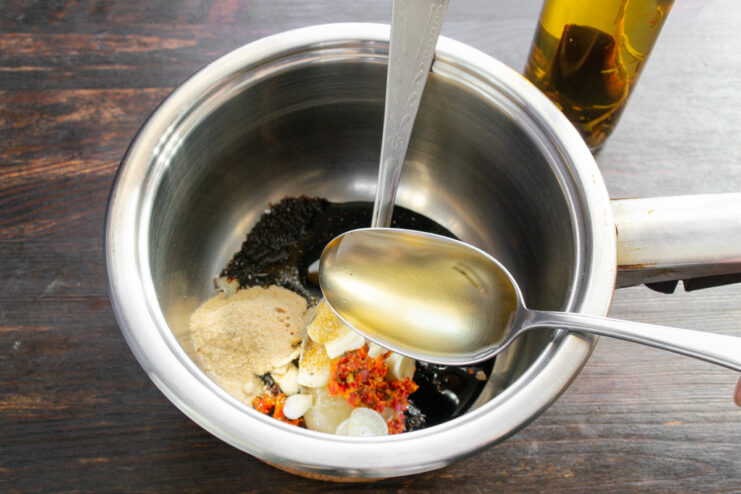 Adding a Tangy Kick with Balsamic Vinegar Pouring balsamic vinegar into the saucepan for a tangy marinade.