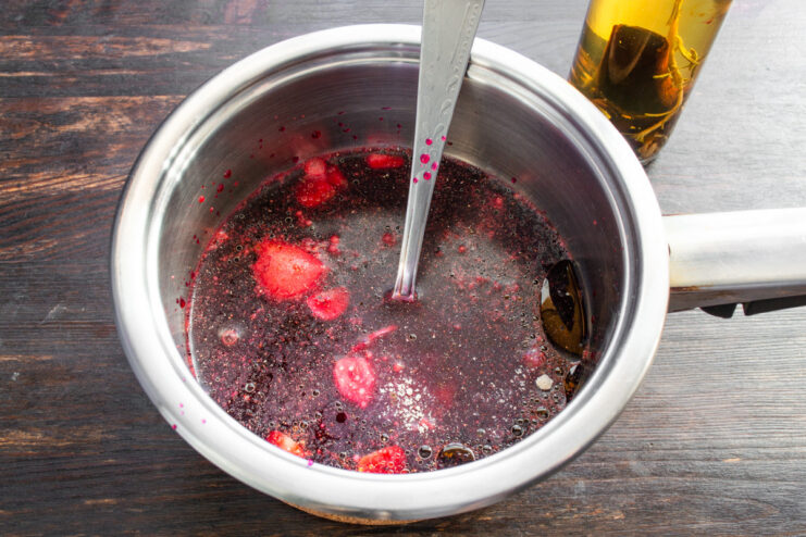 Grating Beet for Natural Color A raw beet being grated on a box grater to color the marinade.