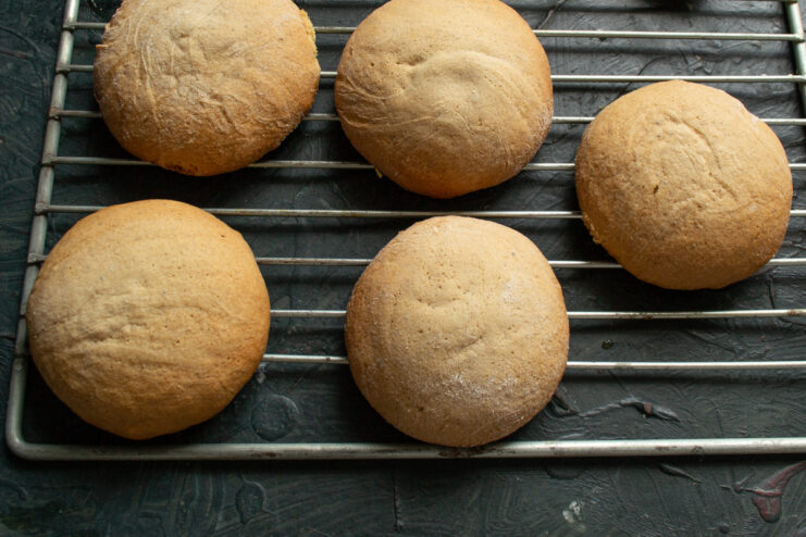 Cooling the freshly baked gingerbread cookies on a wire rack. Hot, freshly baked gingerbread cookies being transferred to a wire cooling rack.