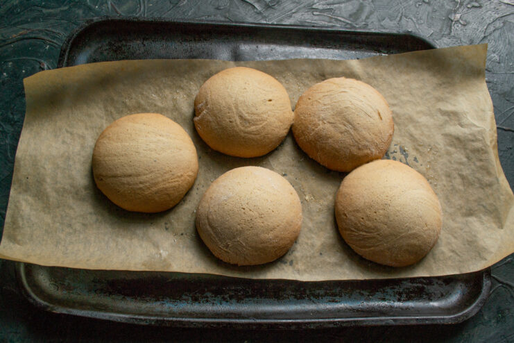 Baking the honey gingerbread cookies until they are perfectly golden. A baking sheet with gingerbread cookies inside a hot oven.