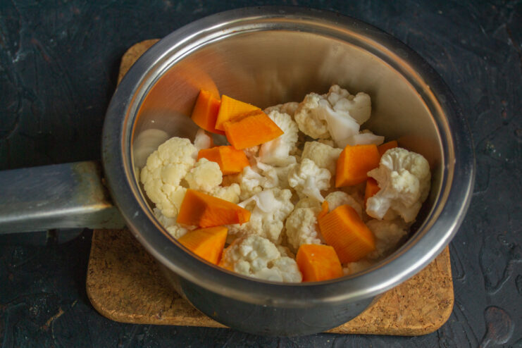 Preparing the Vegetables: How to Blanch Cauliflower and Pumpkin Chopped cauliflower florets and pumpkin cubes in a saucepan with water.