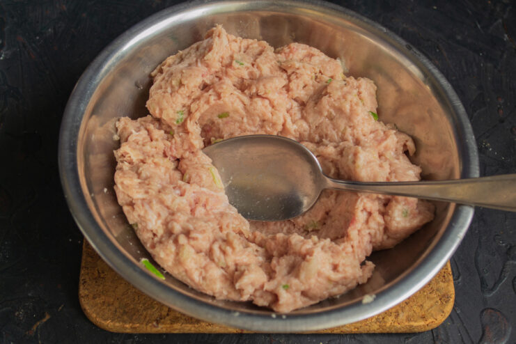 The Perfect Texture: Smoothly Ground Meat for Tender Meatballs A bowl of finely ground, smooth pork mince, ready for seasoning.