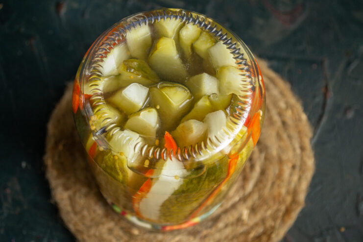 Sealing the Jars for Long-Term Storage A sealed jar of pickles turned upside down on its lid to ensure a proper seal.