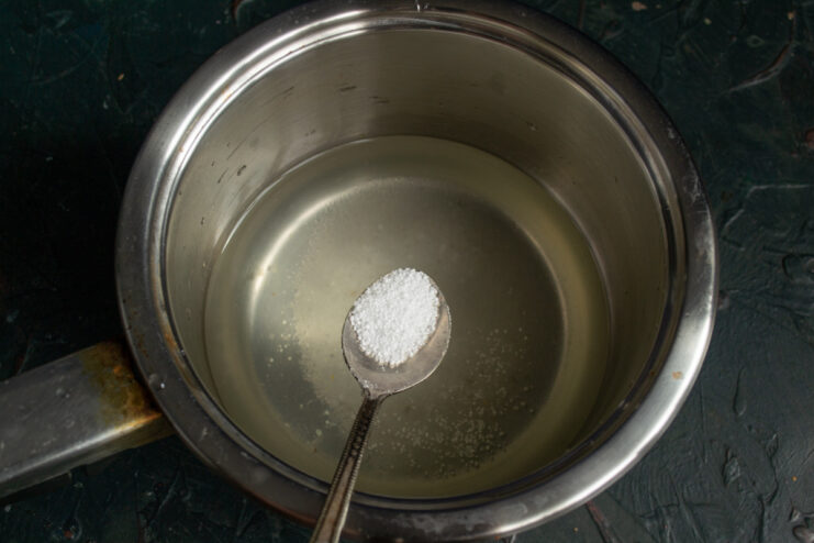 Preparing the Pickling Brine with Sugar, Salt, and Citric Acid A pot with water, sugar, salt, and citric acid being prepared for the pickling brine.
