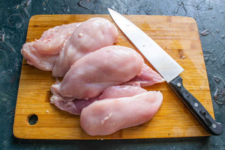 Using Parts of the Chicken Breast for Mincing Close-up of chicken fillet pieces ready to be minced for the omelette.