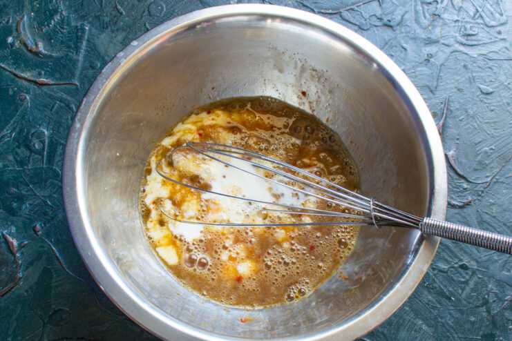 Whisking Eggs and Cream for a Rich Omelette Whisking eggs and heavy cream together in a bowl to create a smooth base.