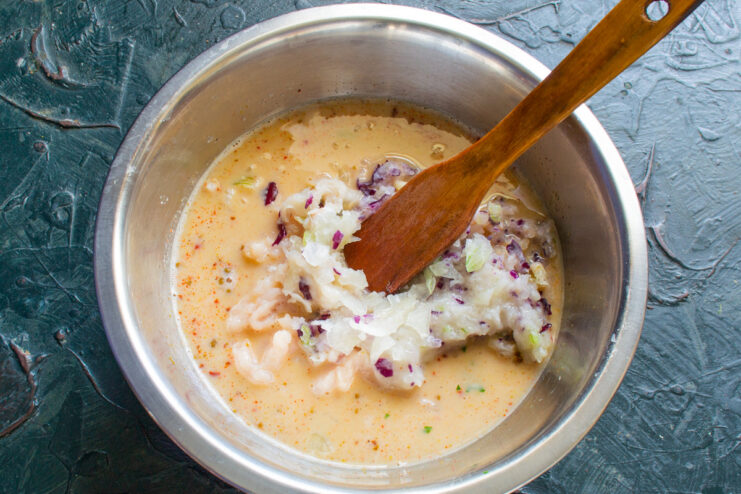 Combining the Minced Chicken with the Egg Mixture Adding the ground chicken mixture to the bowl of whisked eggs and cream.