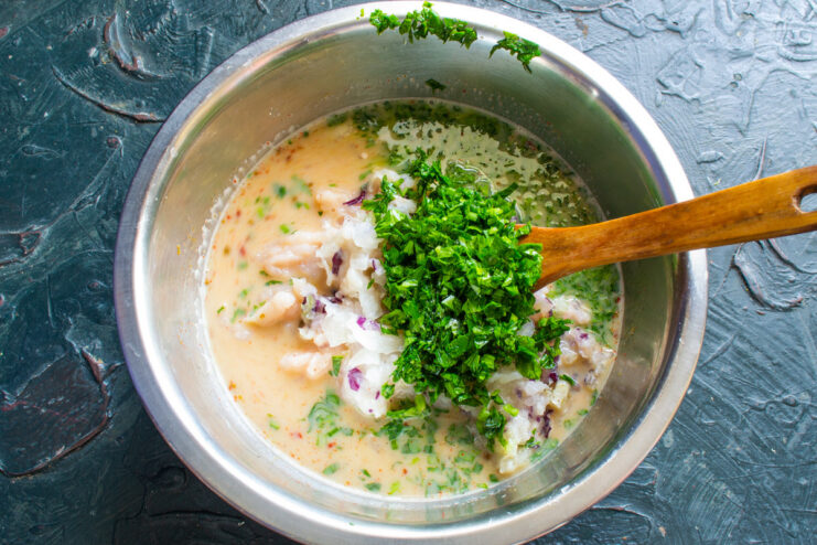 Adding Fresh Cilantro for Flavor A bunch of fresh cilantro being chopped on a cutting board.