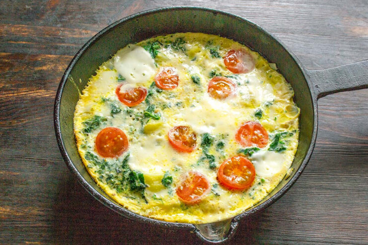 Serving the Hot and Cheesy Nettle and Potato Omelet A slice of the finished nettle and potato omelet on a plate, ready to be served.