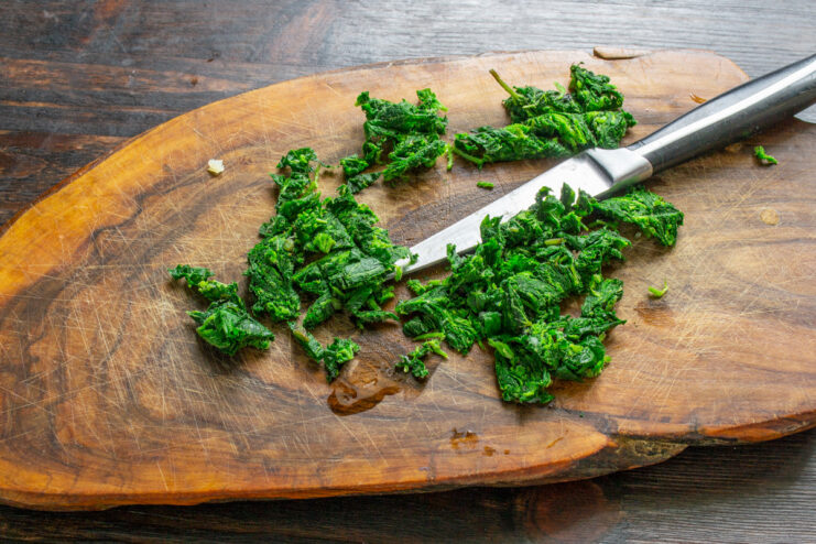 Chopping Nettles for the Omelet Filling A pile of finely chopped blanched nettles on a cutting board.