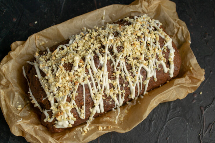 The finished cake, ready to be served with tea or coffee. The finished nut cake with cocoa, drizzled with white chocolate and sprinkled with nuts, ready to serve.