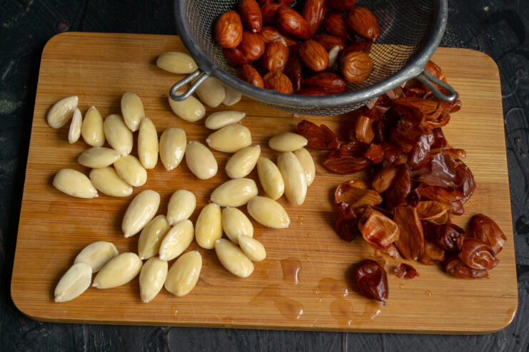 How to easily peel almonds by blanching them in hot water. A bowl of almonds being blanched in boiling water to remove their skins.