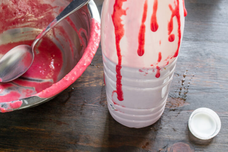 Step 6: Storing the finished smoothie in a bottle for chilling. Pouring the finished pink raspberry kefir smoothie into a glass bottle.