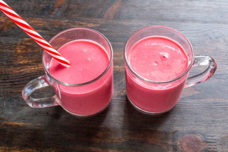 Ready to serve: Chilled raspberry kefir smoothie in glasses. Two glasses filled with the finished raspberry kefir smoothie, ready to be served.