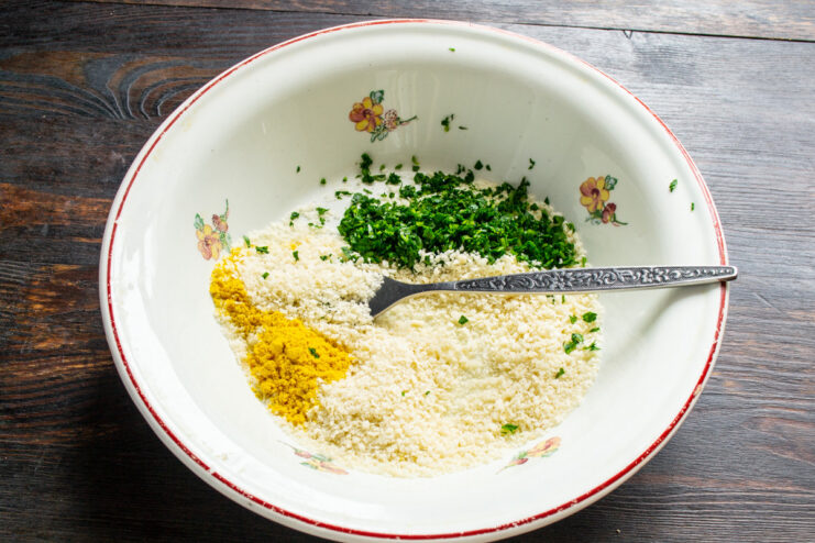 Setting Up the Panko Breading Station A plate filled with panko breadcrumbs for coating the pork chops.