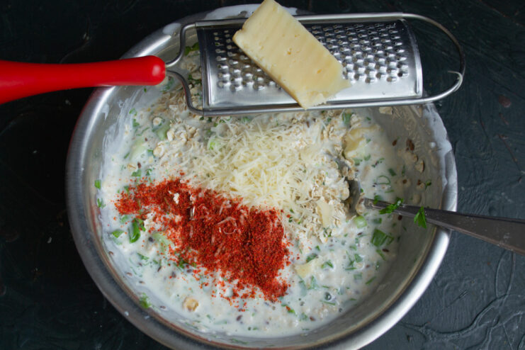 Adding a Cheesy Touch: Grating Hard Cheese A block of hard cheese being grated on a fine grater.