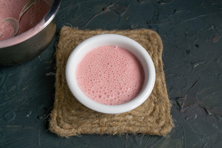 Step 9: Pouring Panna Cotta into Molds Pouring the liquid strawberry panna cotta mixture into individual serving molds.