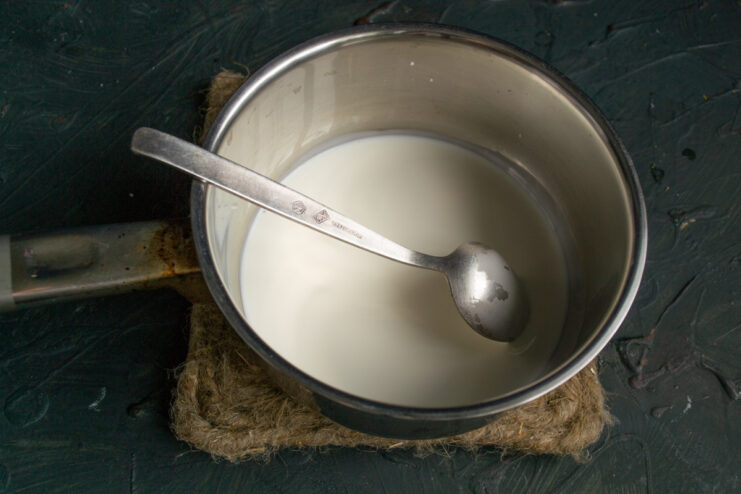 Step 5: Combining Cream, Milk, and Vanilla A saucepan containing a mixture of milk, heavy cream, and vanilla extract.