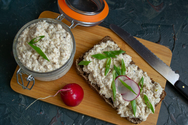 Enjoy Your Healthy and Delicious Homemade Pâté A slice of rye bread generously spread with chicken and walnut pâté, garnished with fresh herbs.