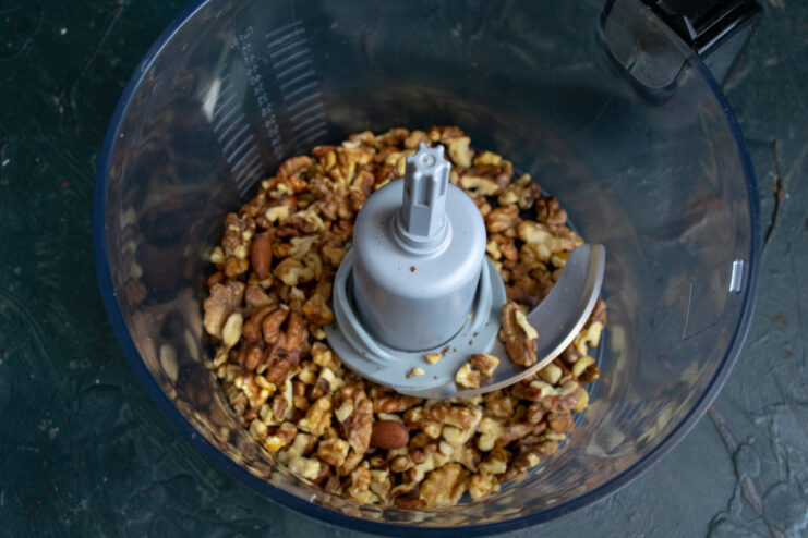 Toasting Walnuts to Enhance Their Flavor Walnuts spread on a baking sheet, ready to be toasted in the oven.